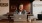 man sits with a drink in front of an open laptop in local restaurant